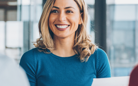 A woman smiling at something.