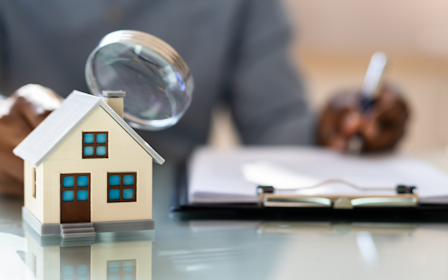 A toy house and a glass.