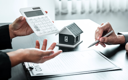 A few people working on a calculator.