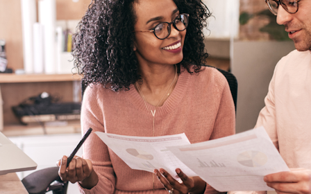 A man and a woman looking at a laptop.