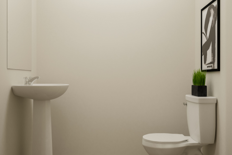 A bathroom with a plant on the toilet.