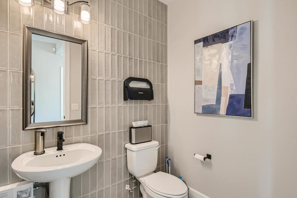 A bathroom with a toilet and a sink.
