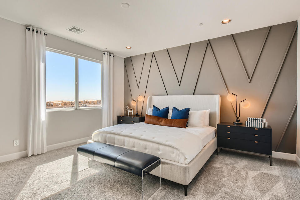 A bedroom with a bed and a couch.