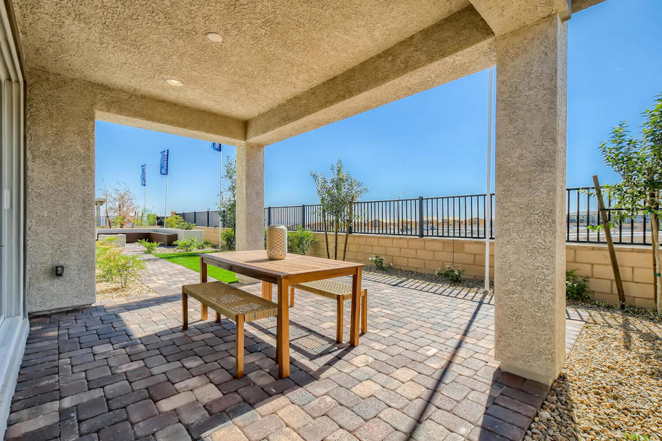 A patio with a table and chairs.