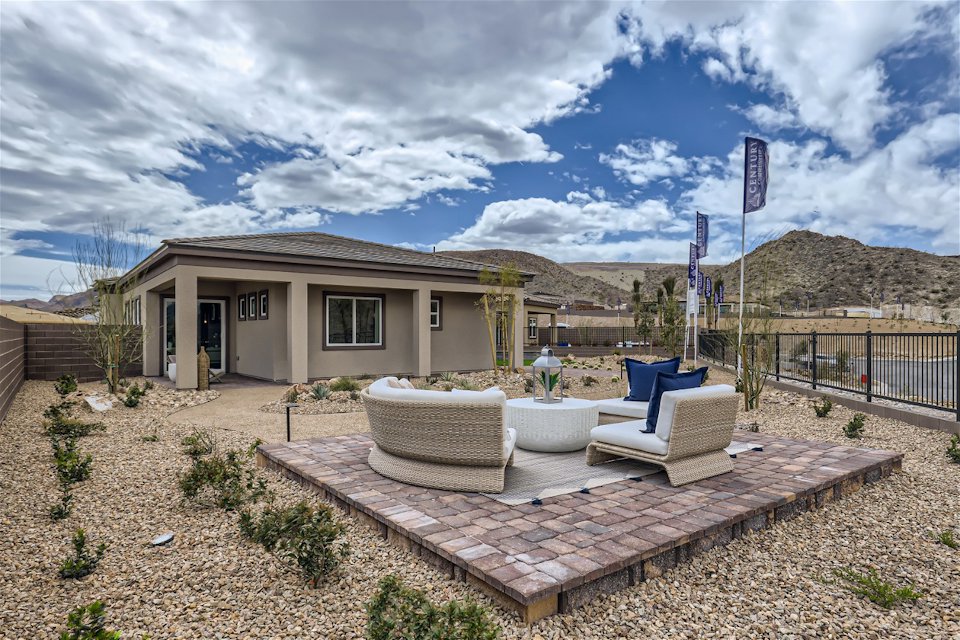 A house with a pool and chairs.