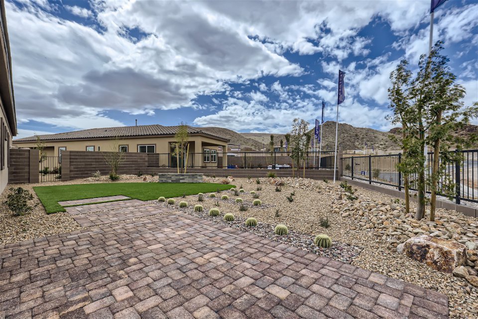 A brick driveway leading to a building.