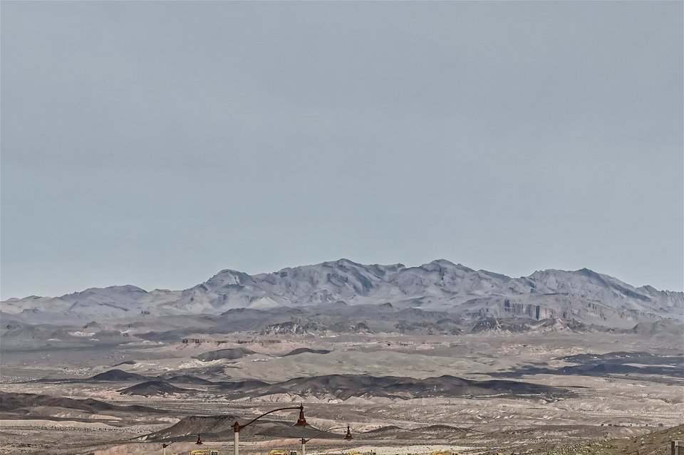 A snowy landscape with mountains in the background.