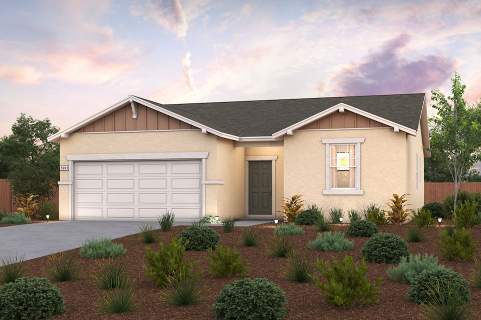 A house with a garage and bushes in front of it.