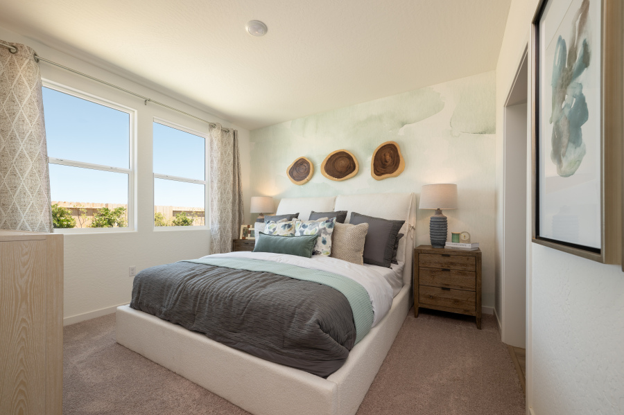 A bedroom with a bed and a window.