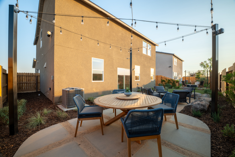A patio with tables and chairs.