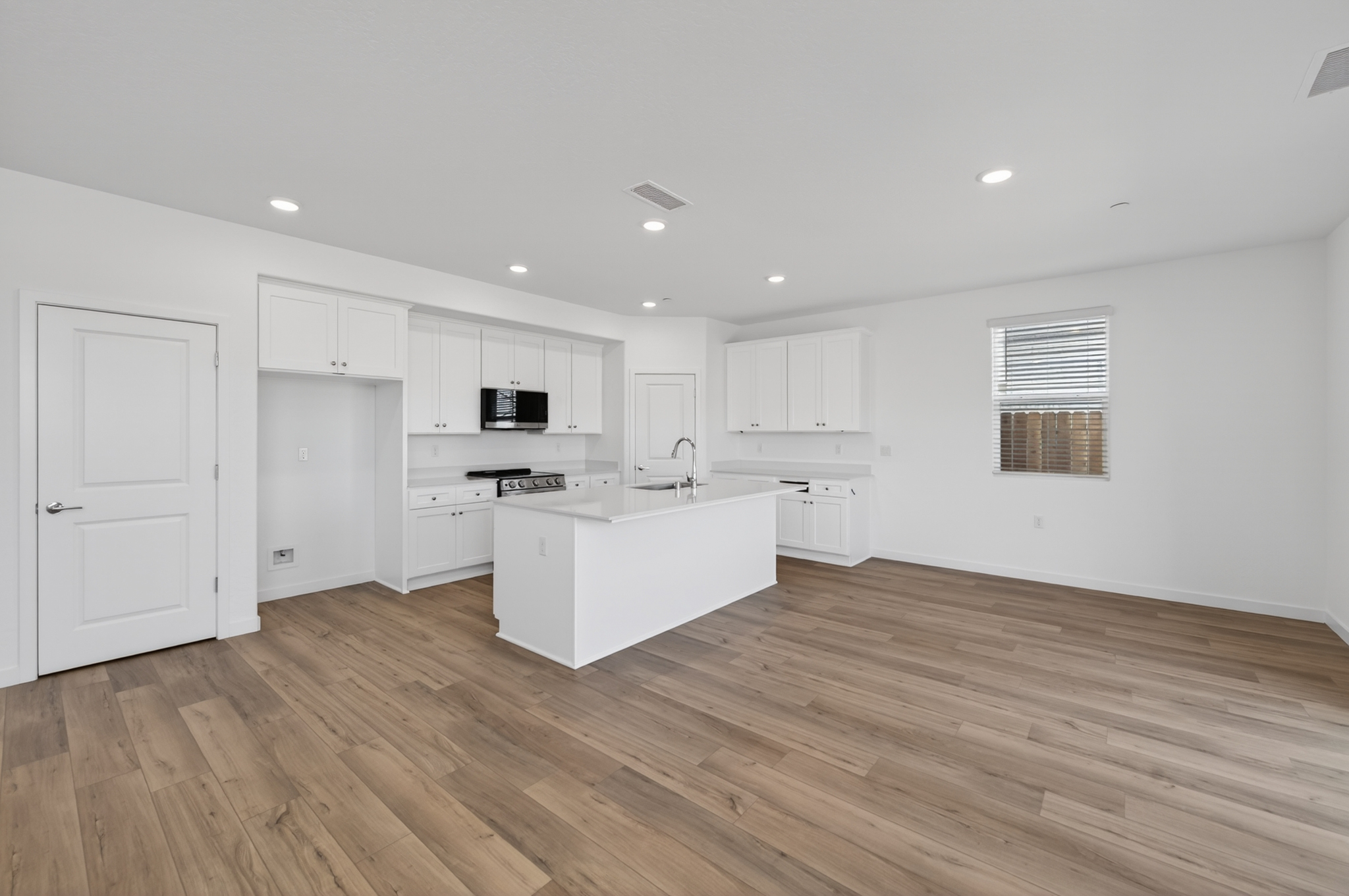 A kitchen with white cabinets.