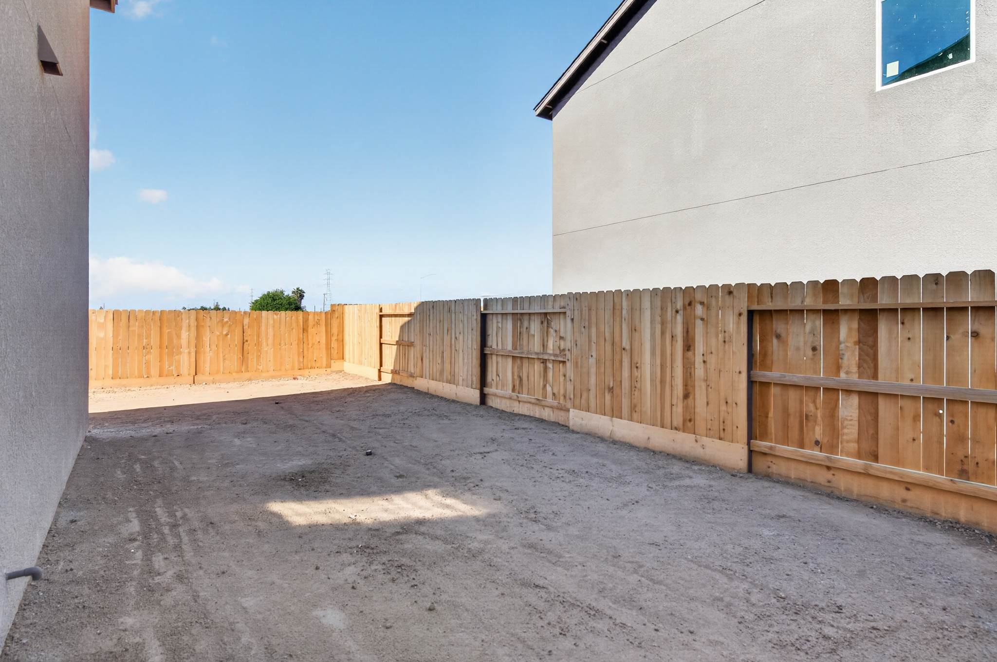 A fenced off area with a building in the background.