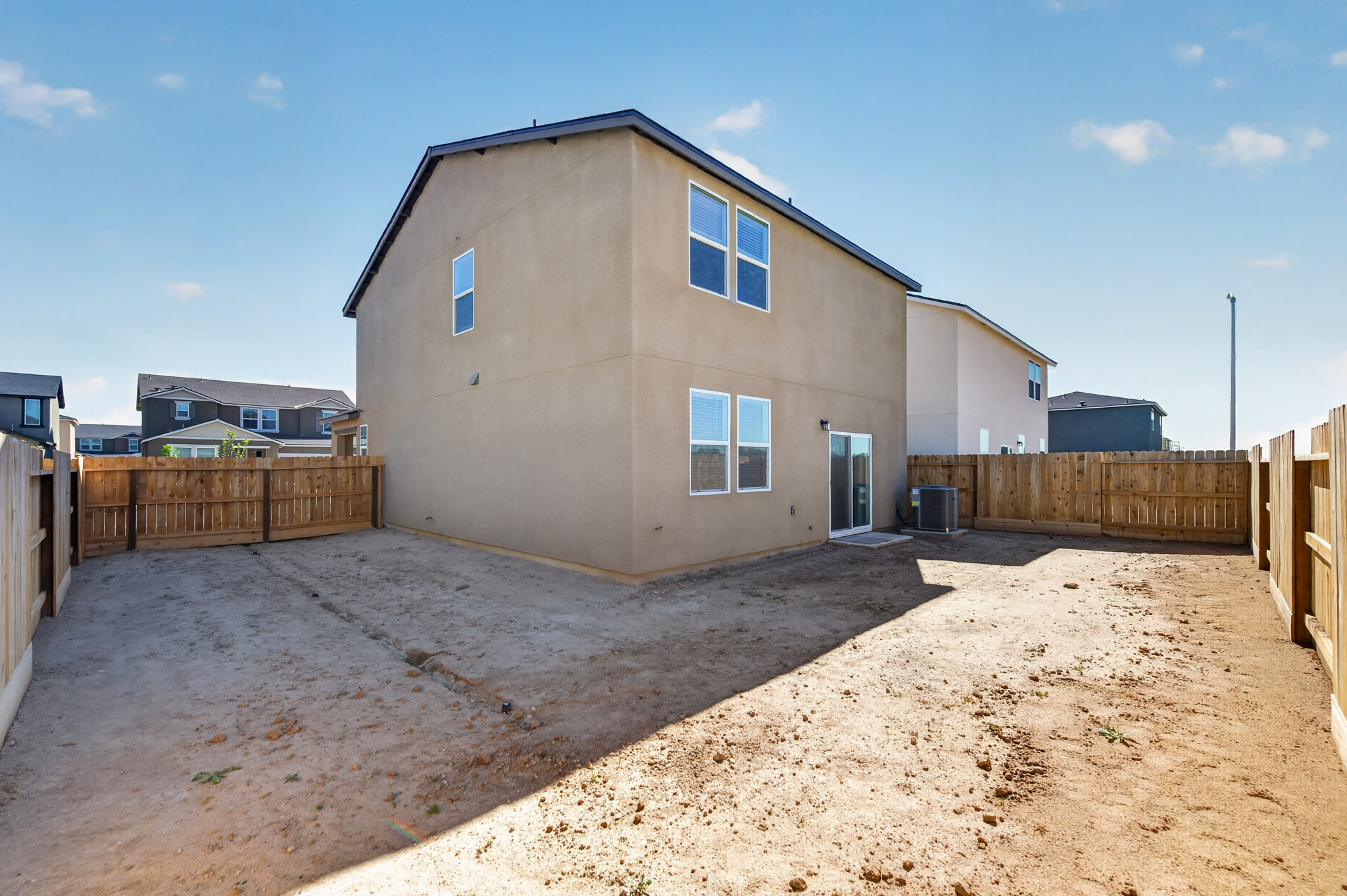 A building with a dirt yard.