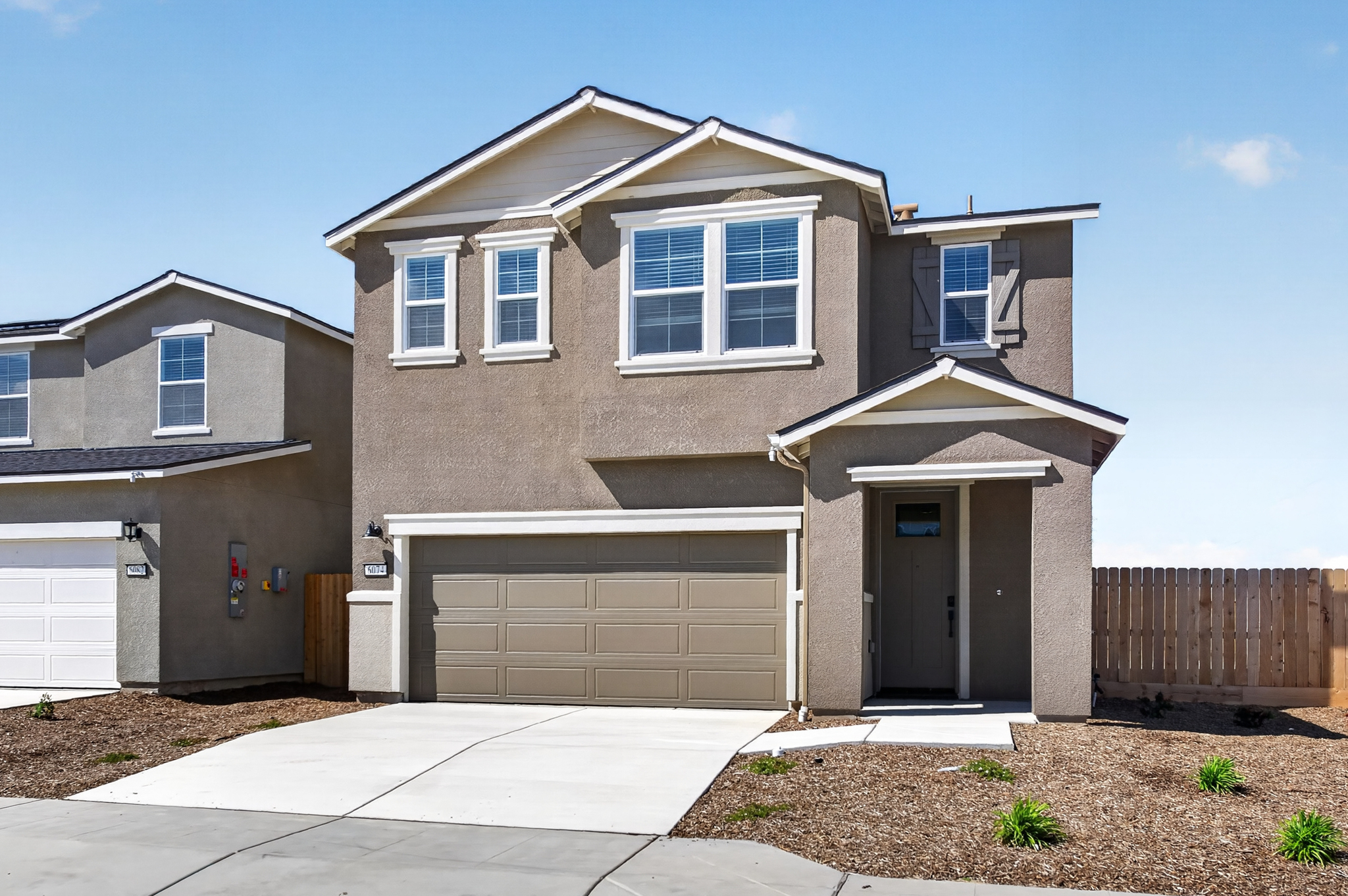 A house with garages and a fence.