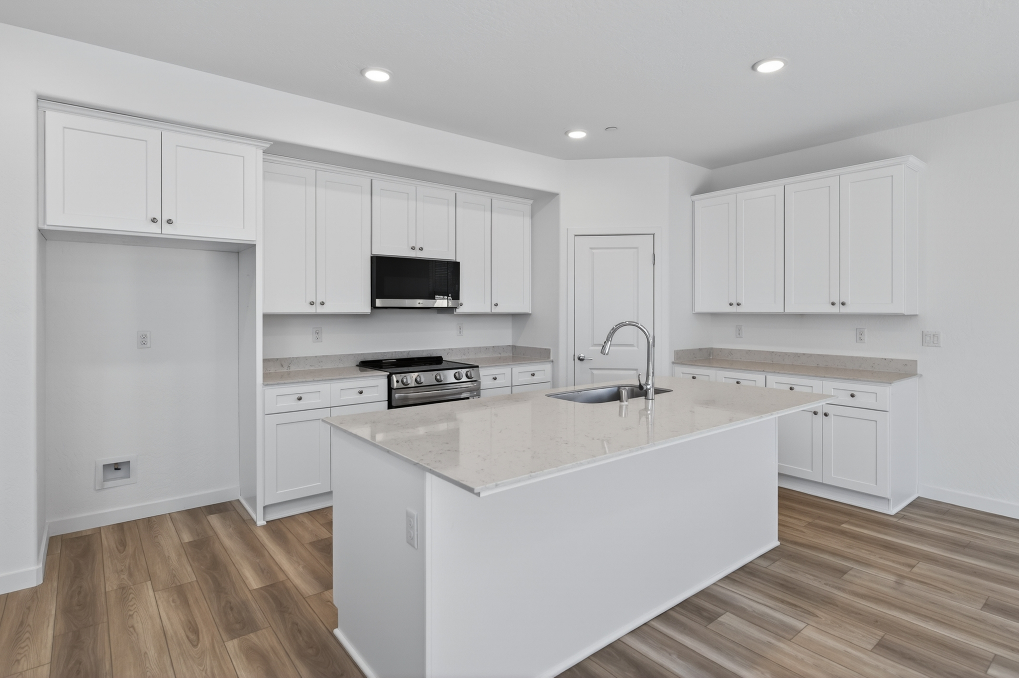 A kitchen with white cabinets.