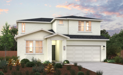 A house with a garage and bushes in front of it.