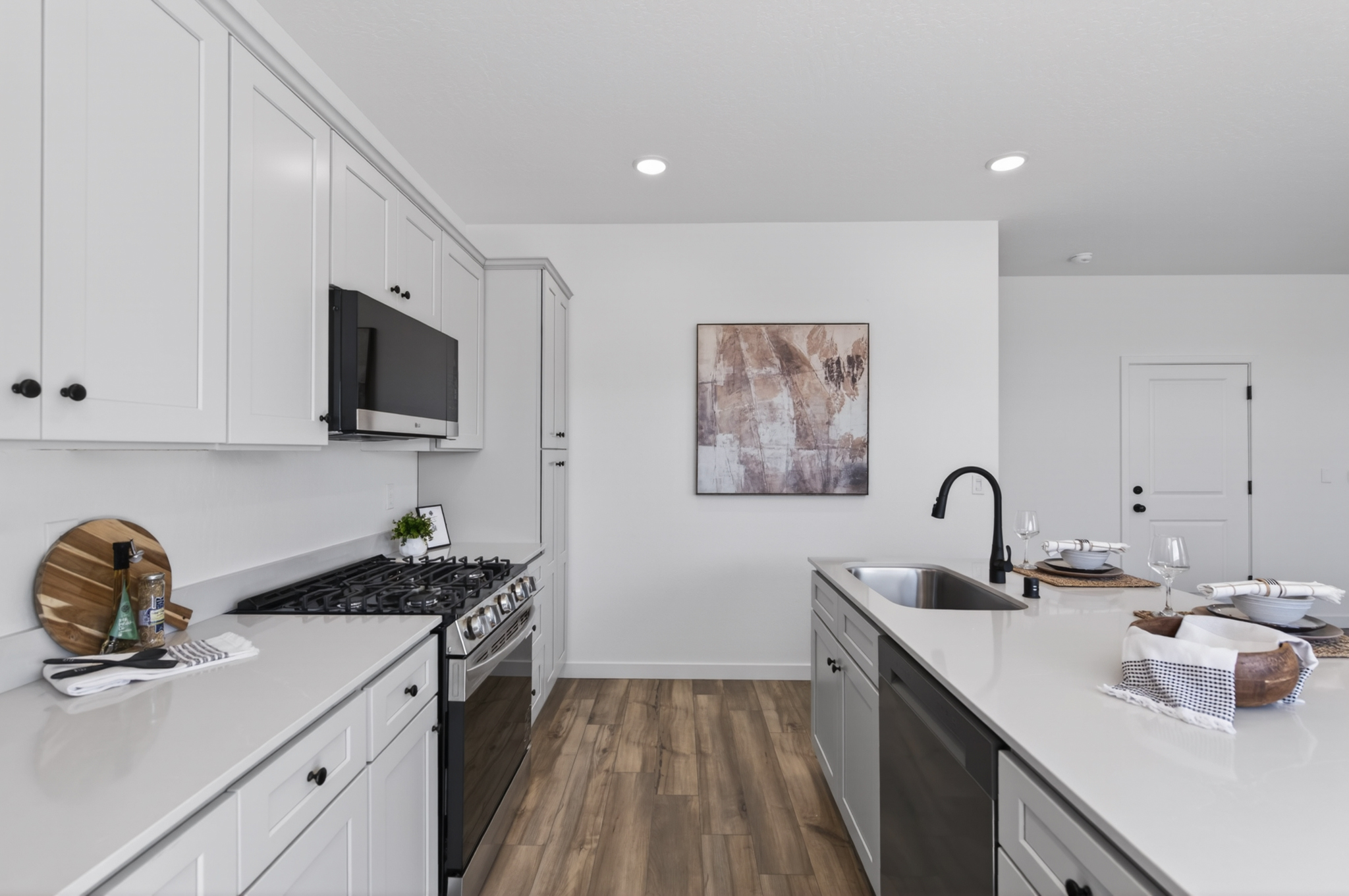 A kitchen with white cabinets.