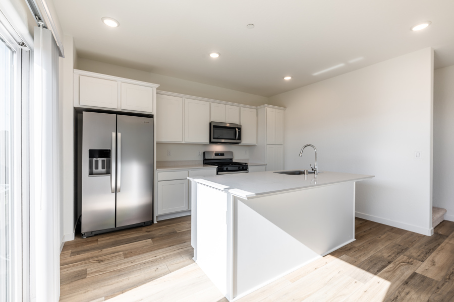 A kitchen with white cabinets.