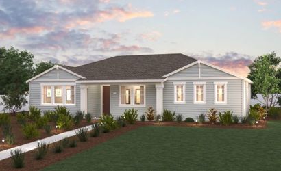 A house with a lawn and a fence in front of it.