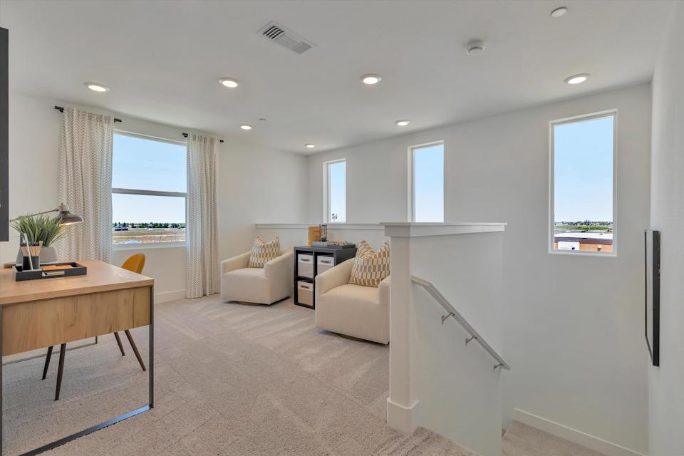 A living room with a table and chairs.