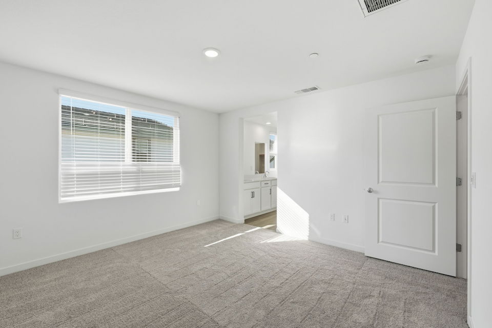 A room with white walls and a window.