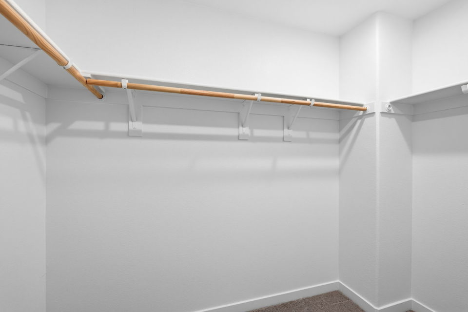 A white wall with a wooden railing.