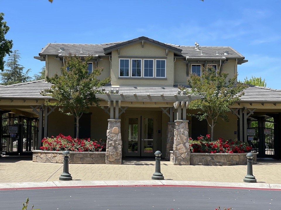 A house with a gate and trees.