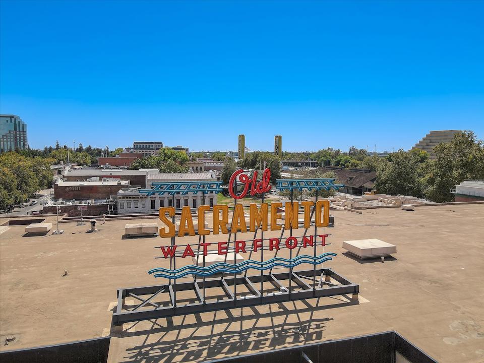 A sign in a sandy area.