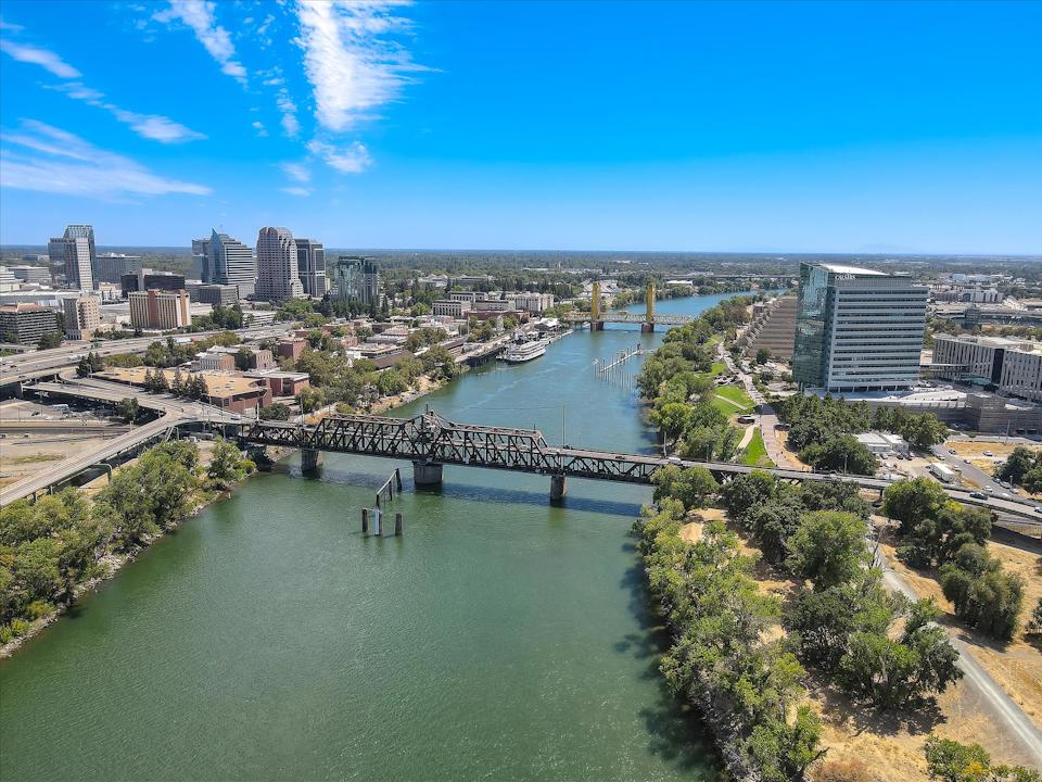 A body of water with a bridge and buildings around it.