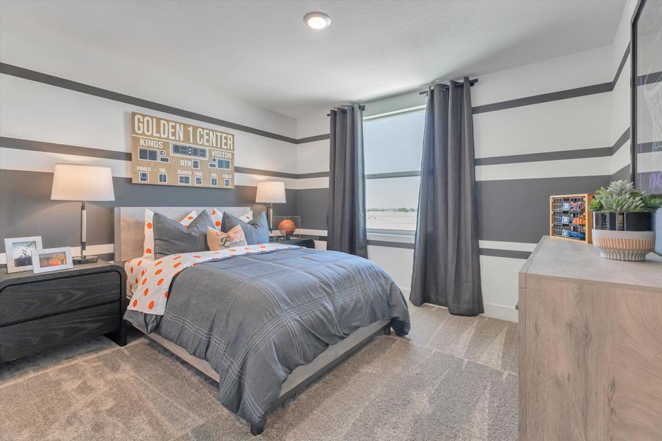 A bedroom with a large window.