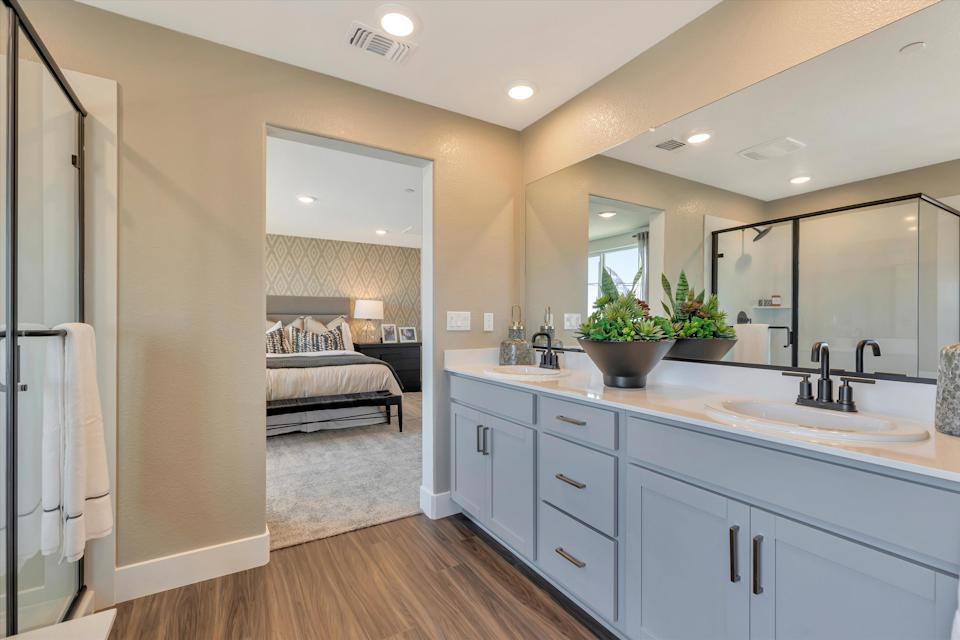 A bathroom with a bed and sink.