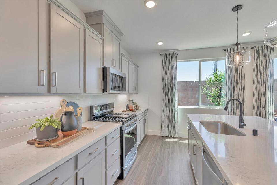 A kitchen with white cabinets.