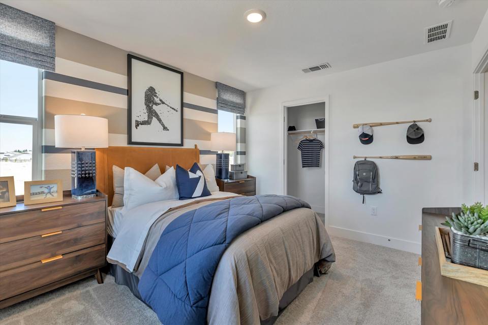 A bedroom with a bed and a shelf with shoes on it.