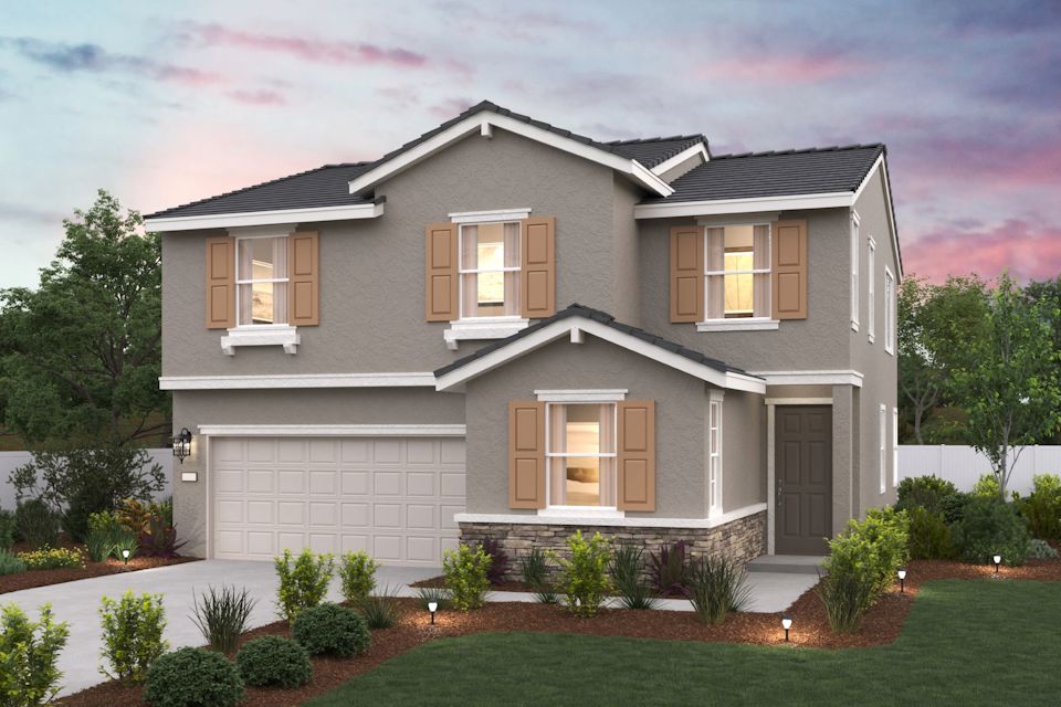 A house with a garage and a lawn in front of it.