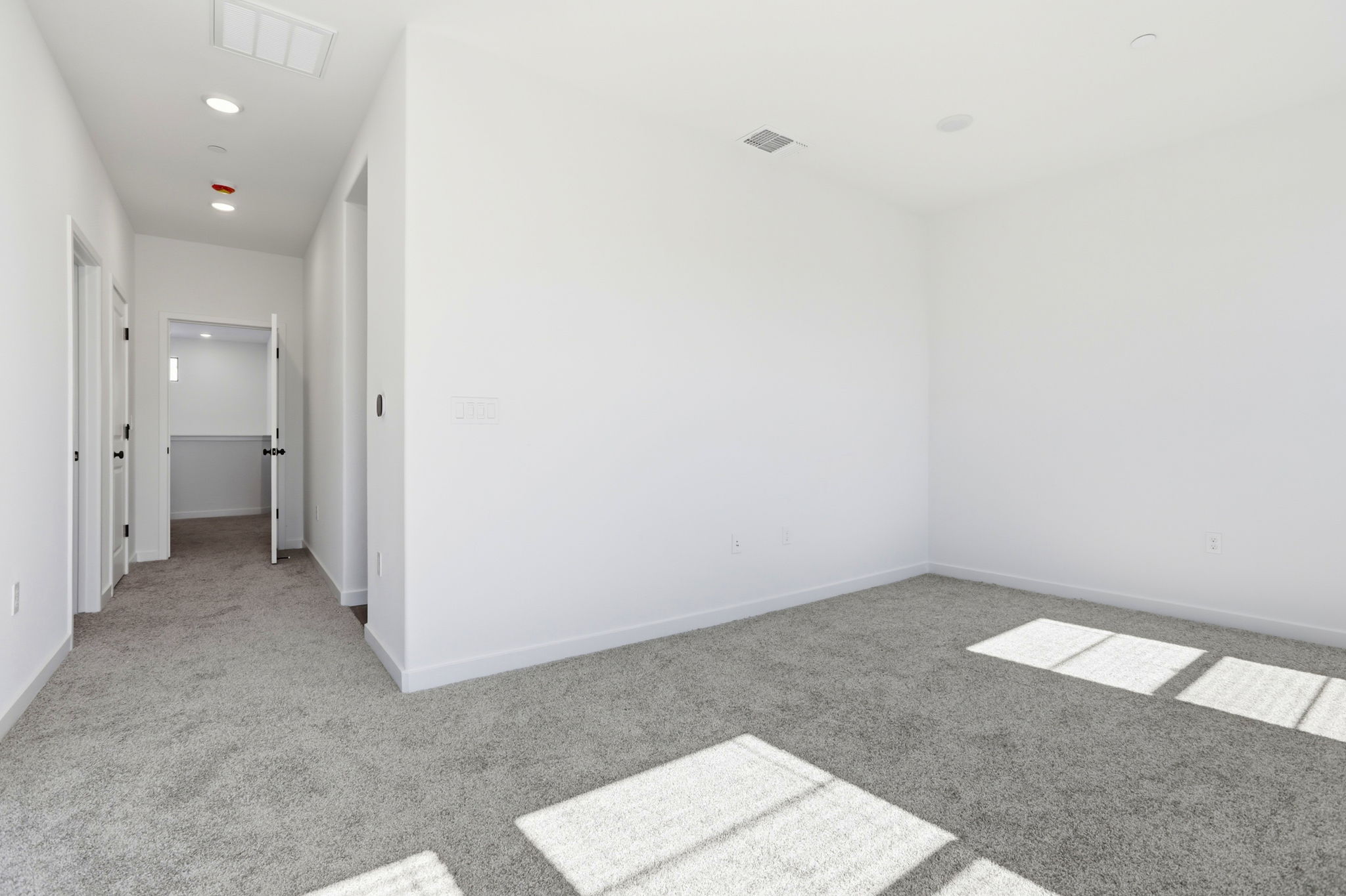 A hallway with white walls.