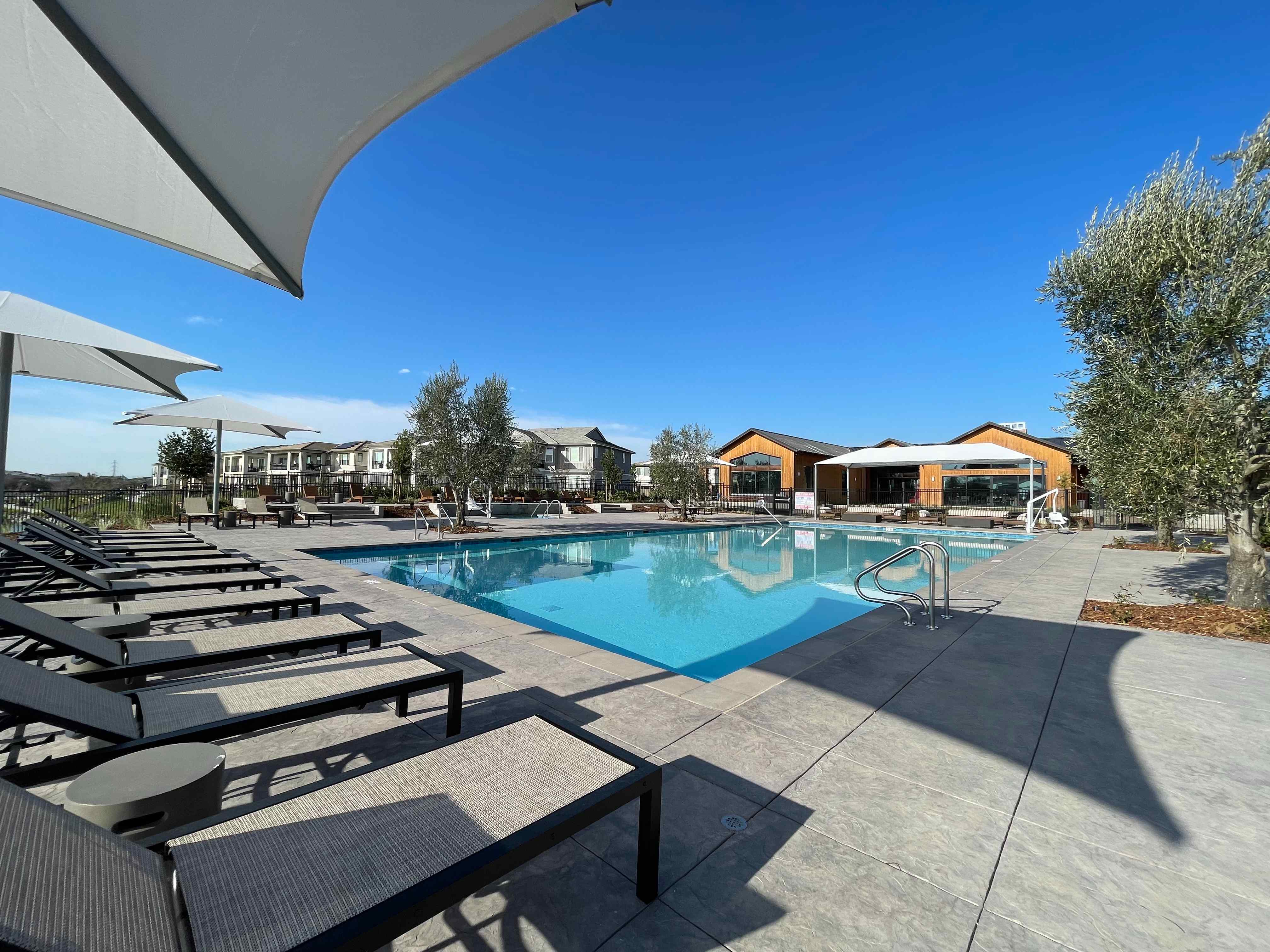 A swimming pool with chairs around it.