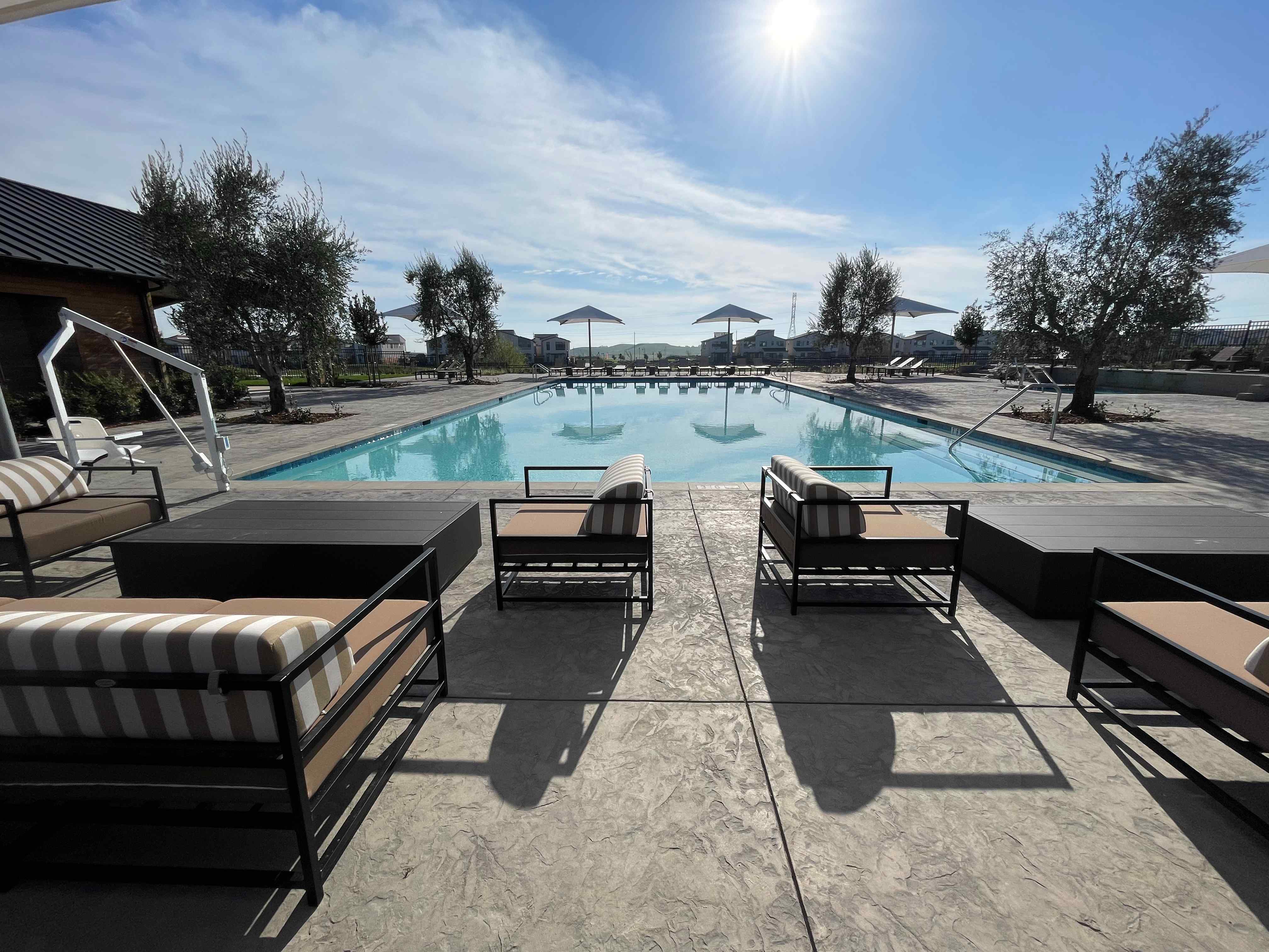 A pool with chairs around it.
