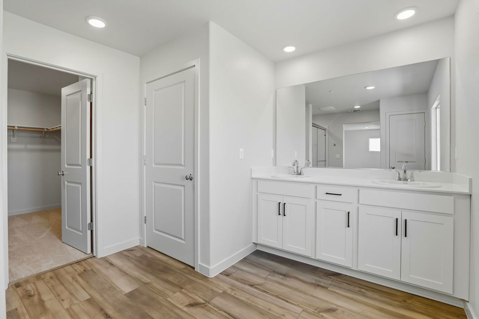 A kitchen with white cabinets.
