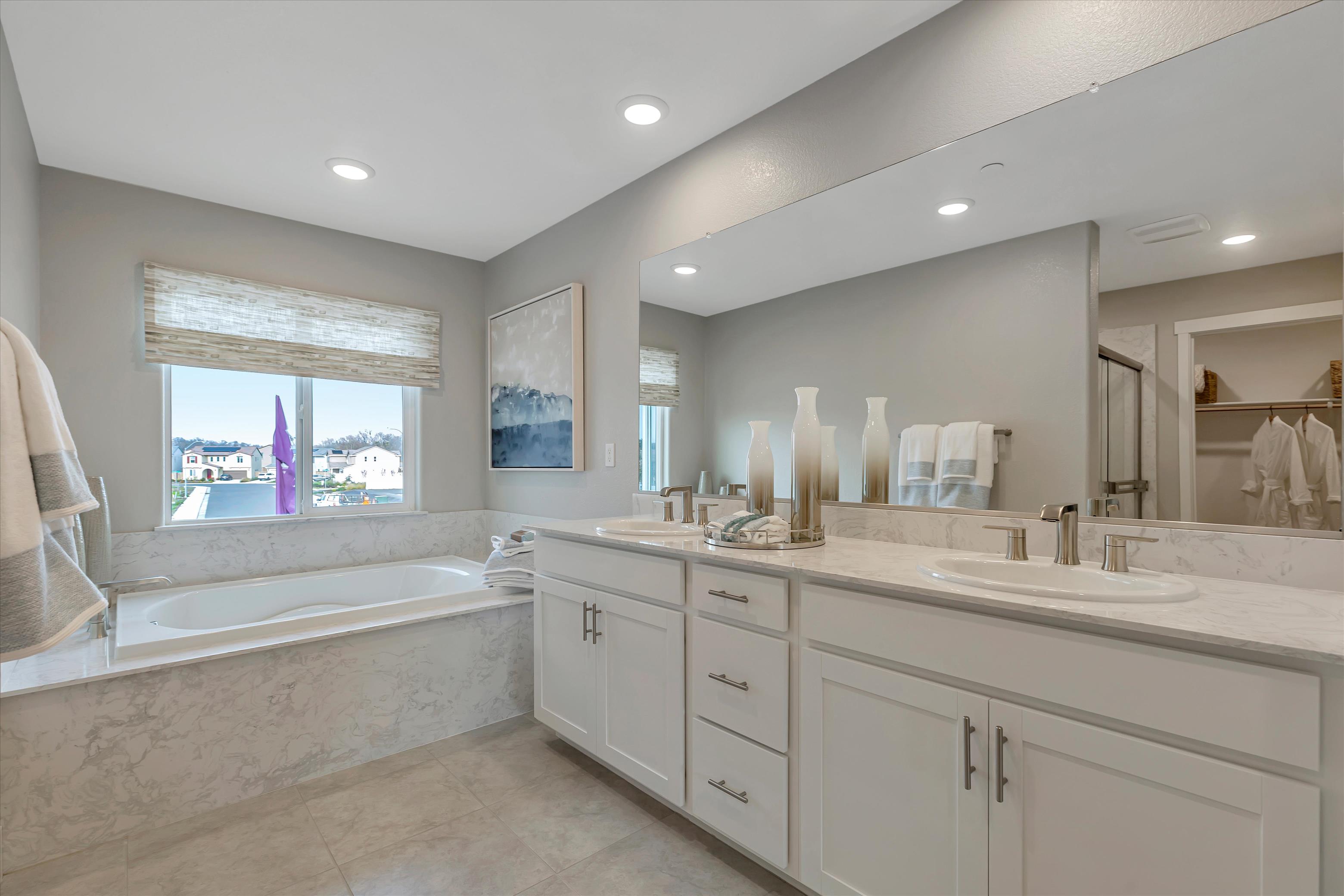 A bathroom with a tub sink and a bathtub.