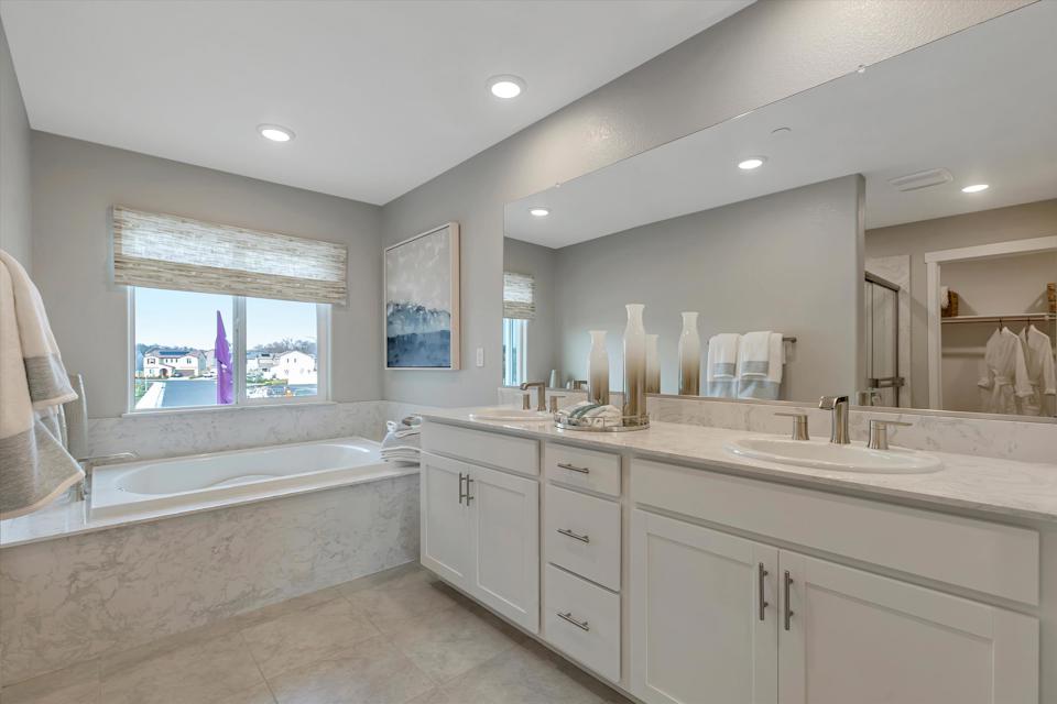 A bathroom with a tub sink and a bathtub.