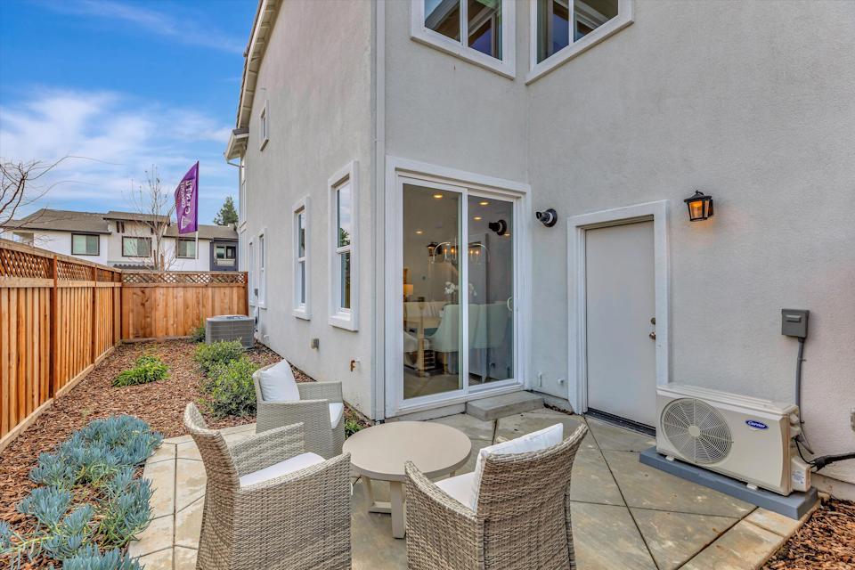 A patio with chairs and a table.