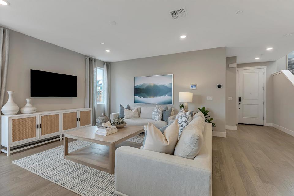 A living room with a large television.