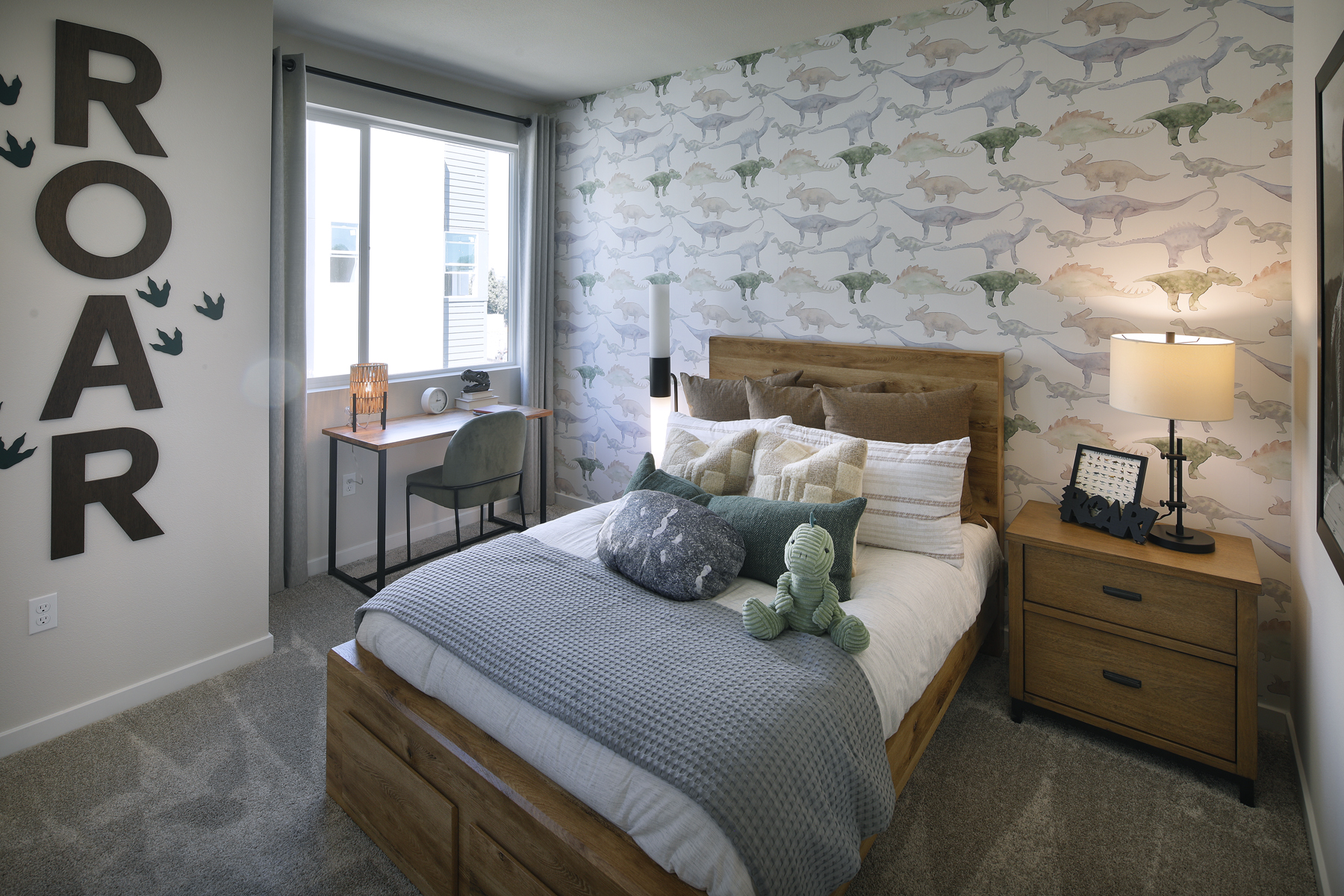 A bedroom with a bed and a desk.