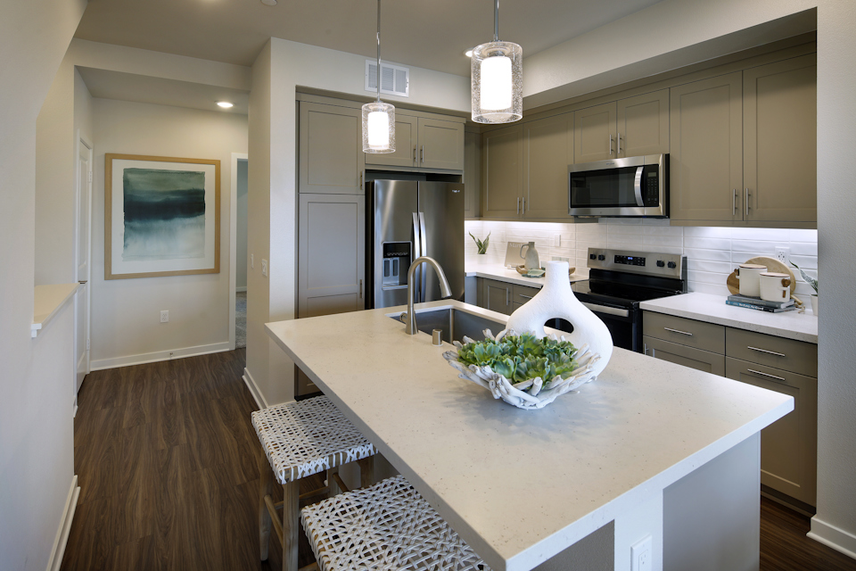 A kitchen with a table and chairs.