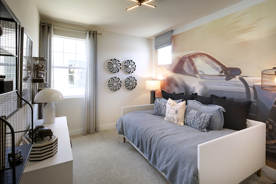 A bedroom with a bed and a lamp.