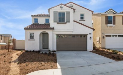 A white house with a garage.