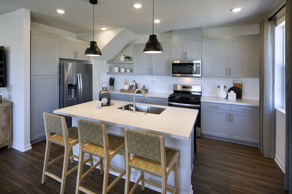 A kitchen with a table and chairs.
