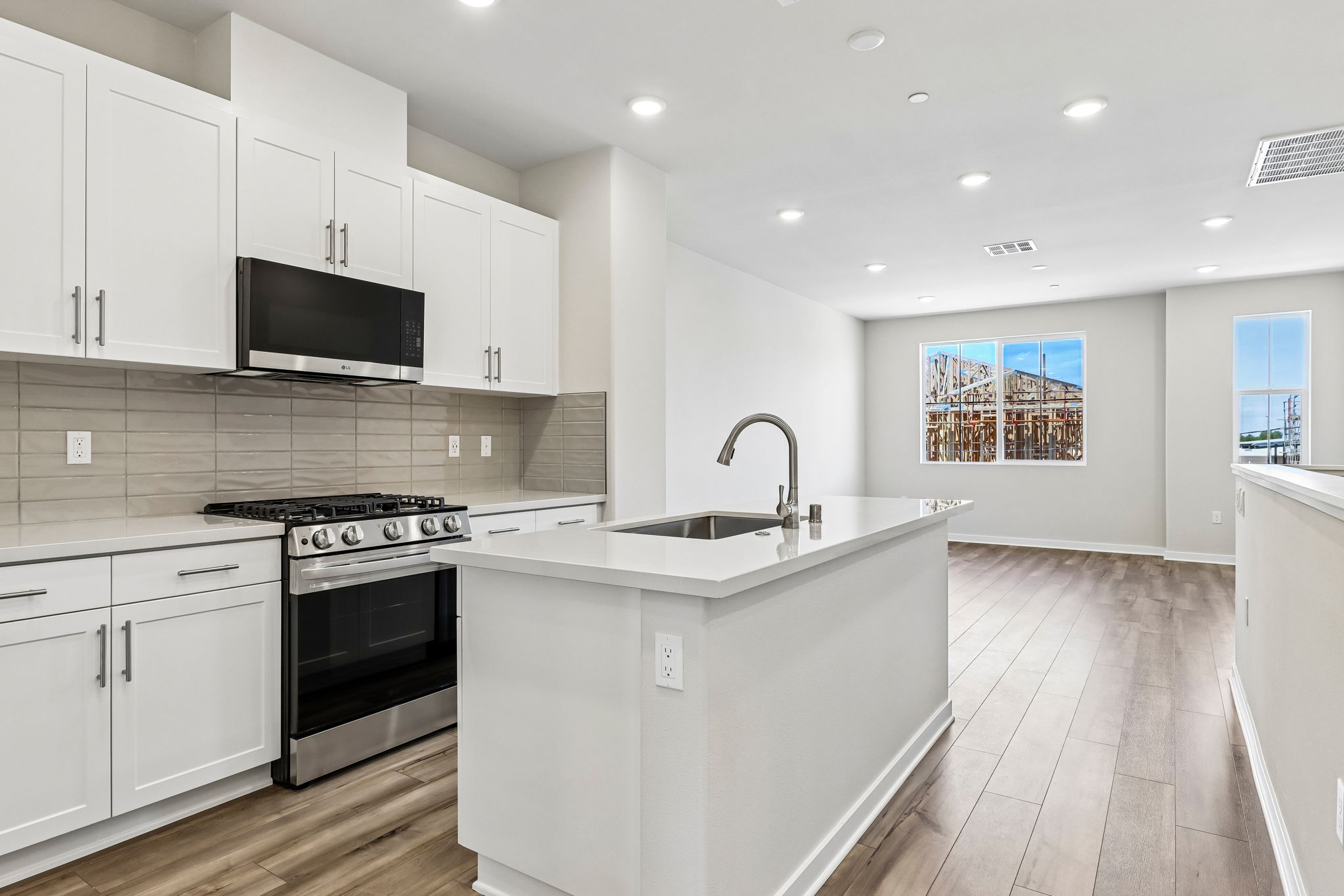 A kitchen with white cabinets.