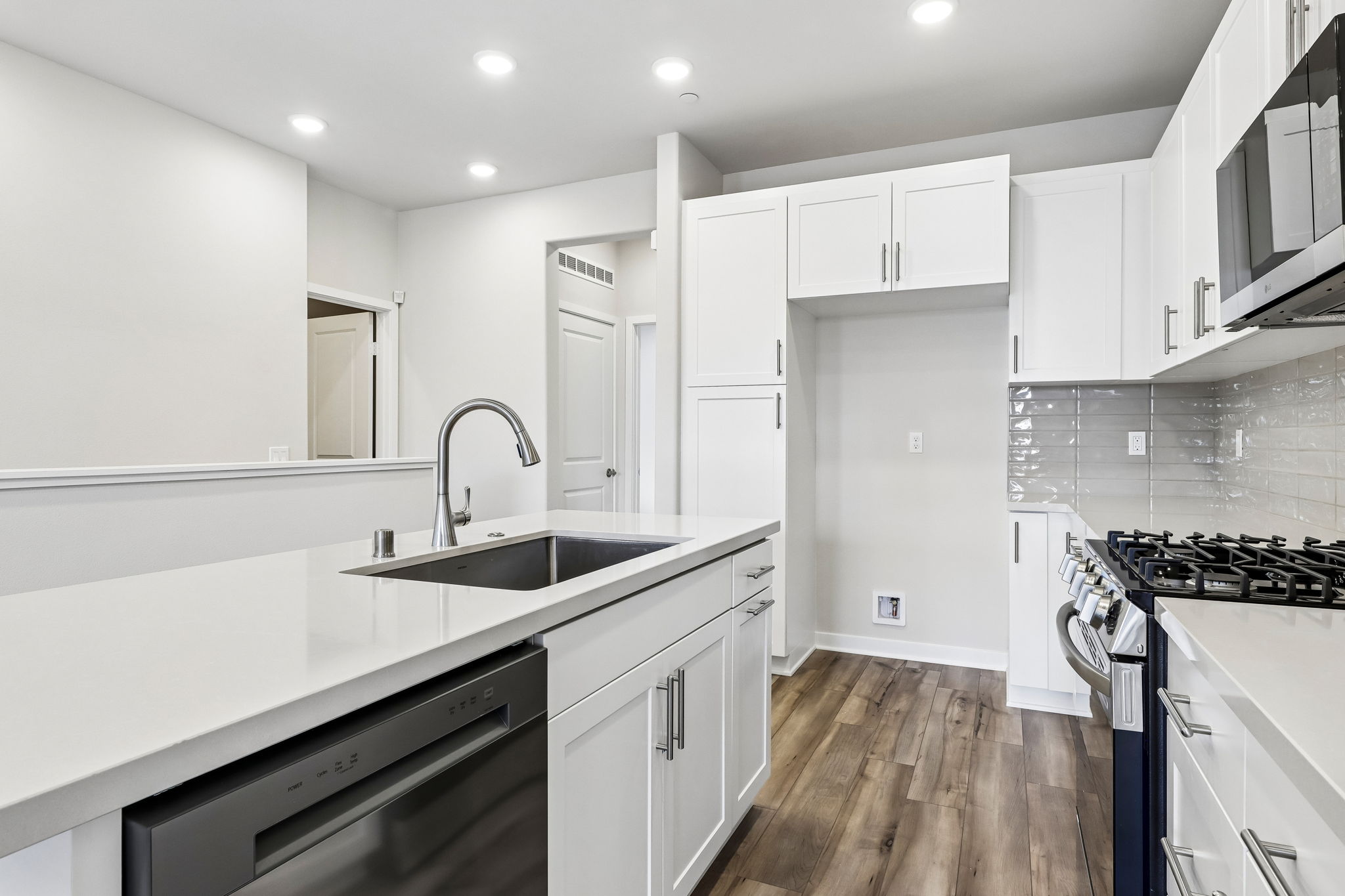 A kitchen with white cabinets.