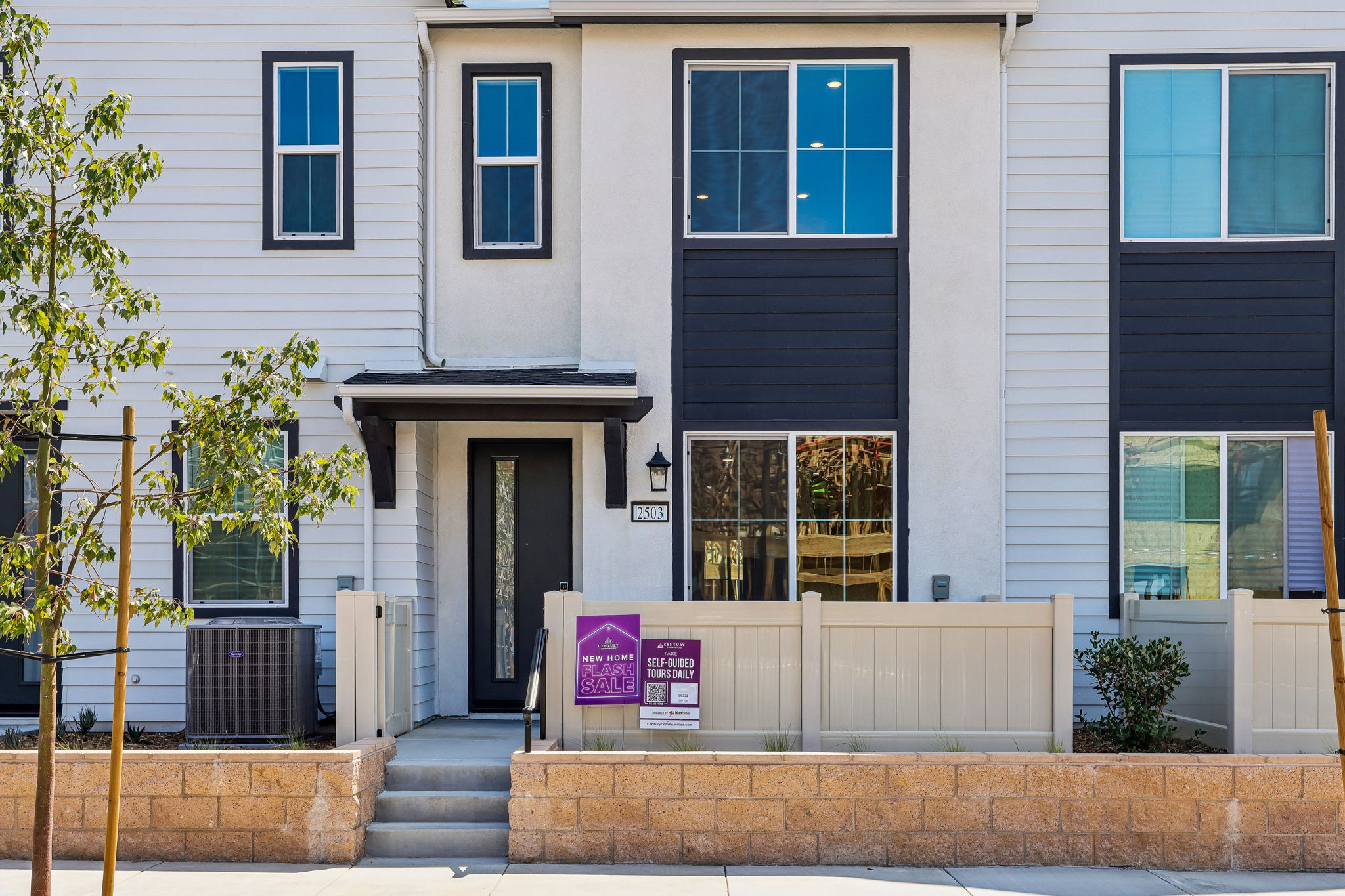 A building with a sign in front.